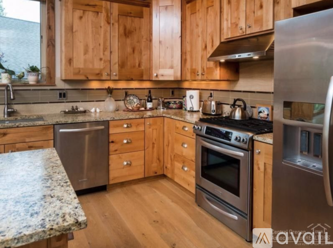 A kitchen with wooden cabinets and stainless steel appliances.