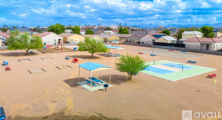 An aerial view of a playground with a blue shade structure and a swimming pool.