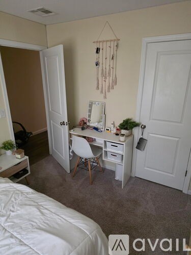 A room with a bed, desk, and chair.