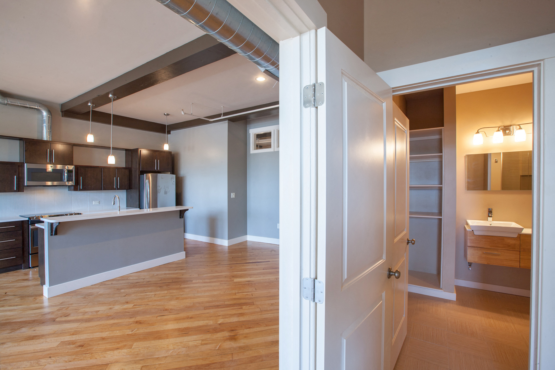 a view of a kitchen and living room from a doorway