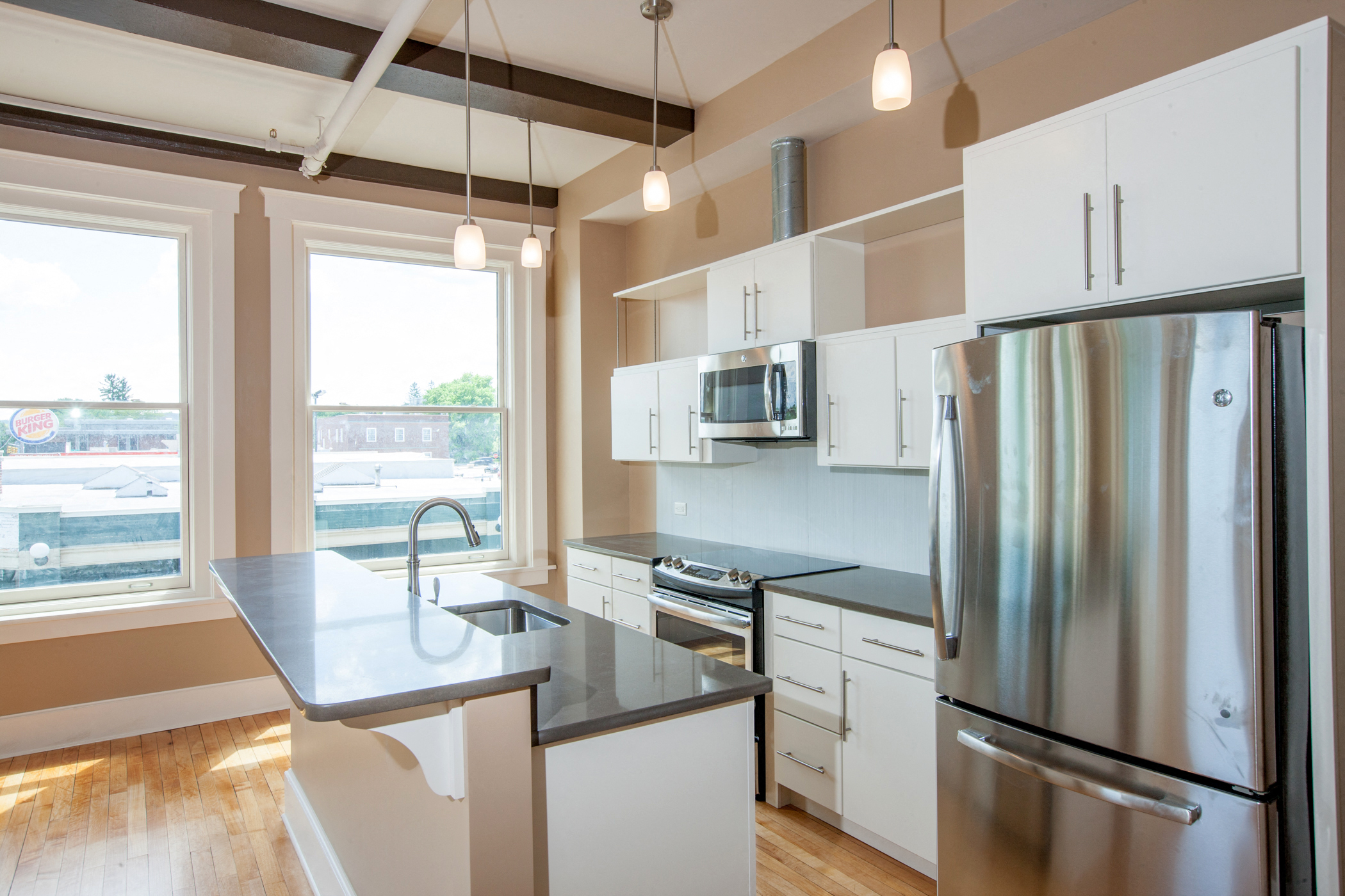 a kitchen with stainless steel appliances and a large window