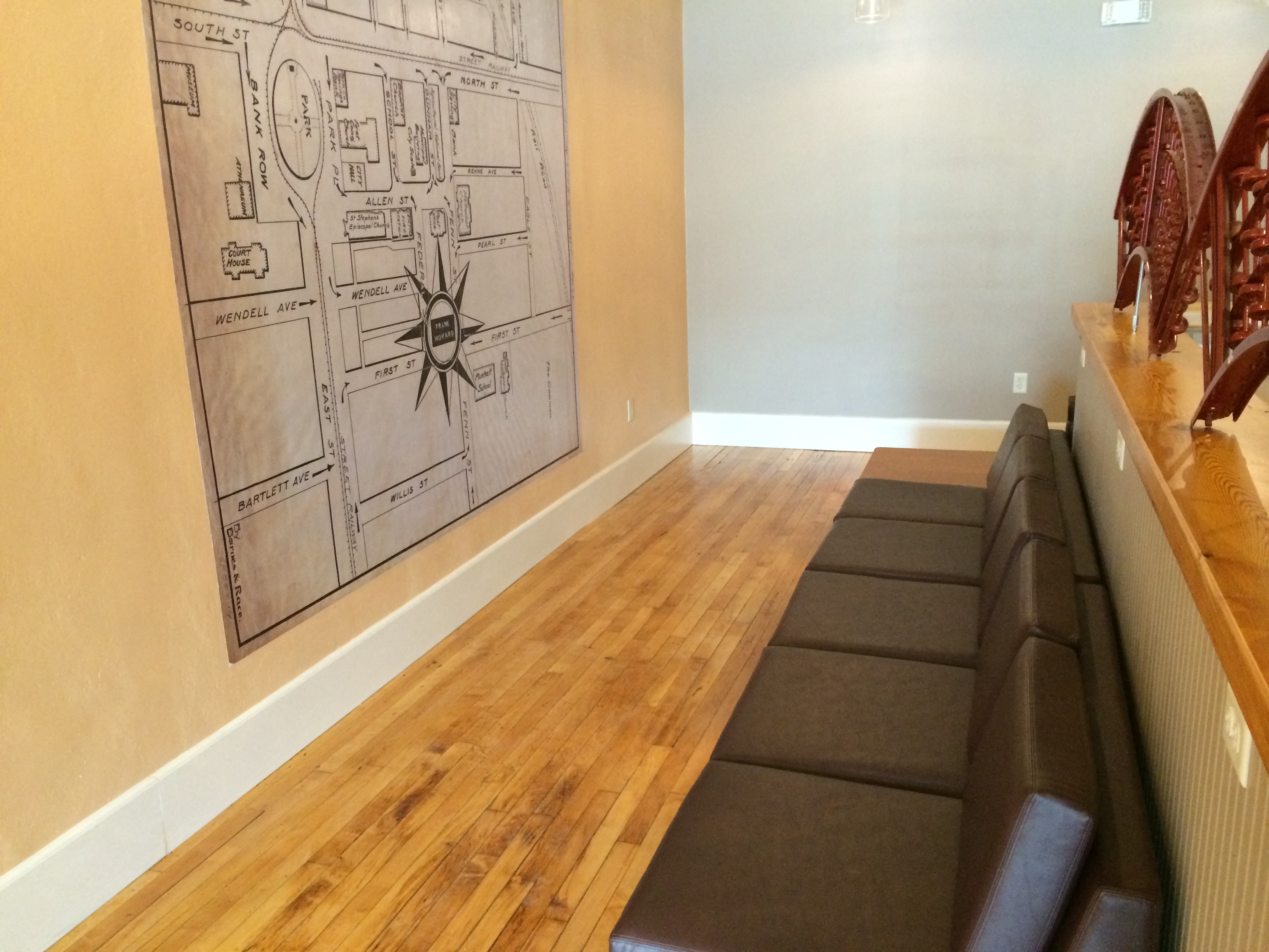 a living room with a couch and a drawing on the wall