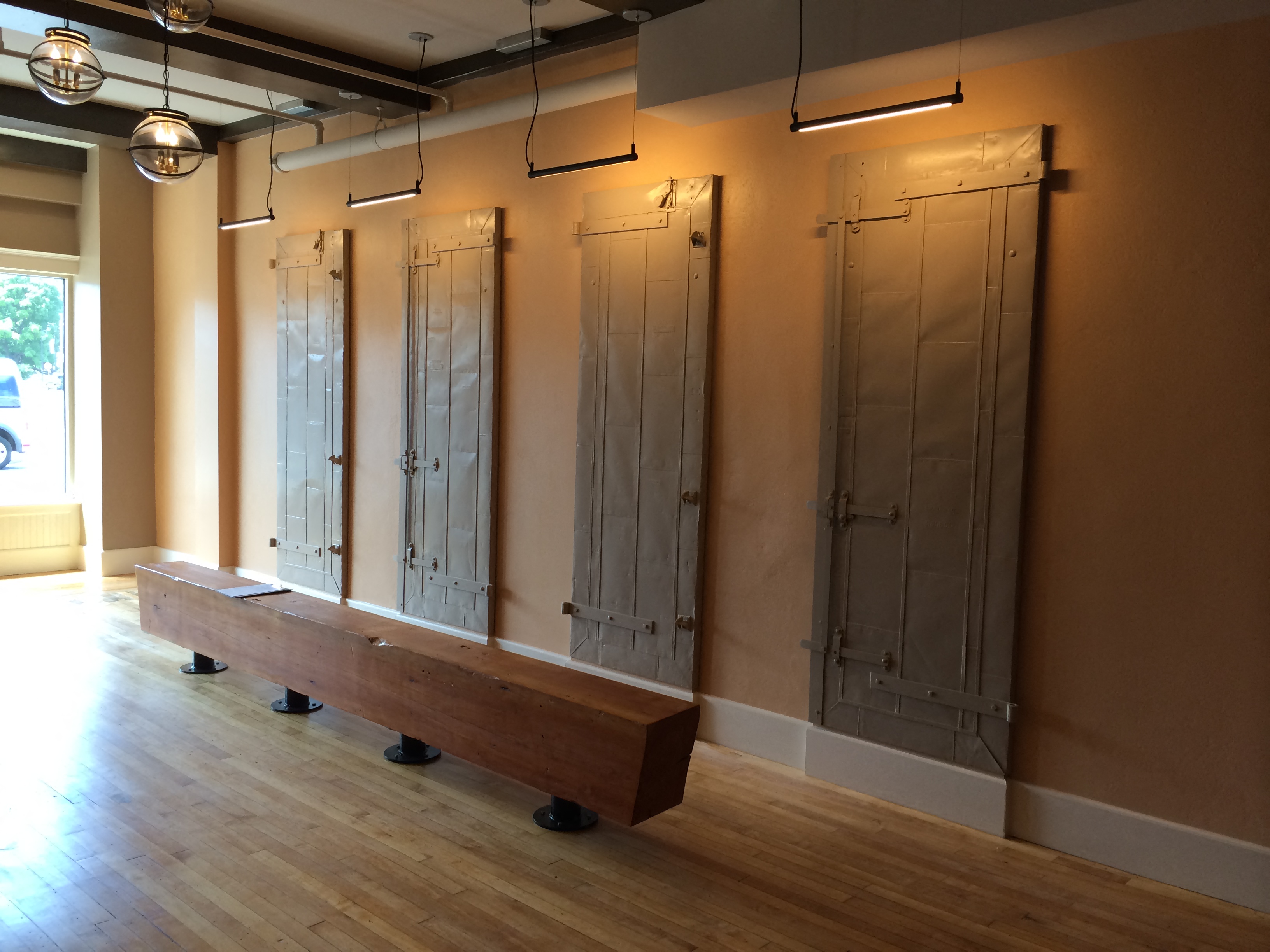 a row of doors in a room with a bench