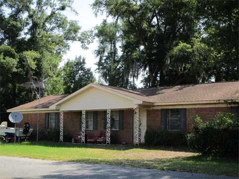 A house with a red brick exterior and a yellow roof.