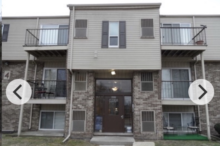 A two-story apartment building with balconies on the second floor.