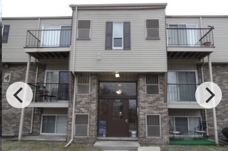 A two-story apartment building with balconies on the second floor.