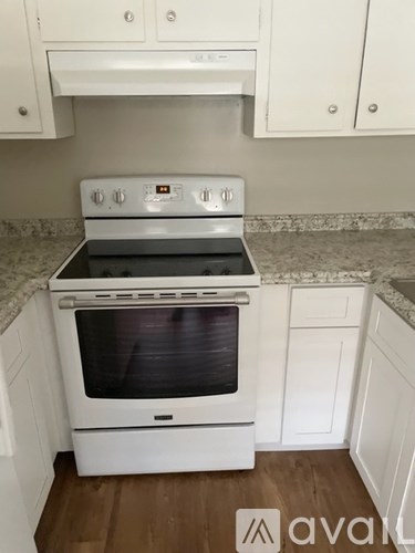 A white oven with a black glass door is in a kitchen.