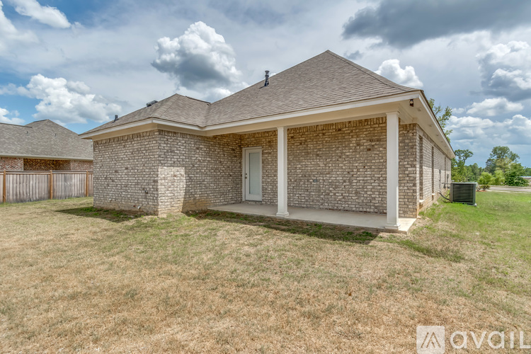A house with a brick facade and a white door is for sale.