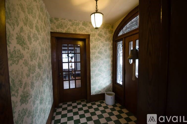 A room with a checkered floor and a wooden door.
