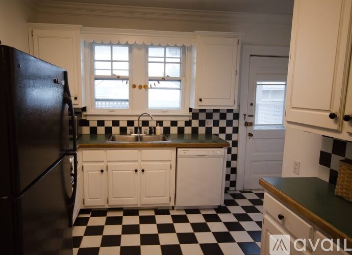A black and white checkered floor in a kitchen.