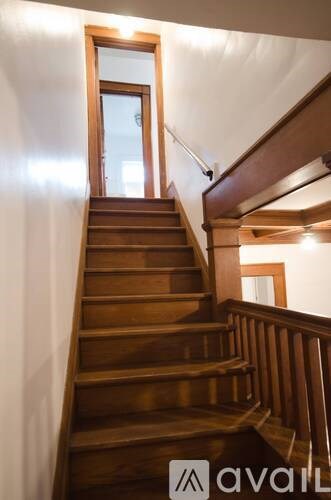 A wooden staircase with a window on the side.