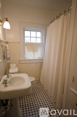 A bathroom with a sink, toilet and shower.