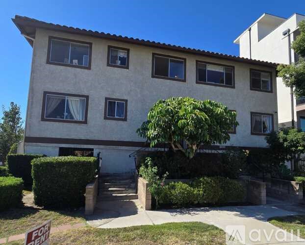 A house with a red for sale sign in front of it.