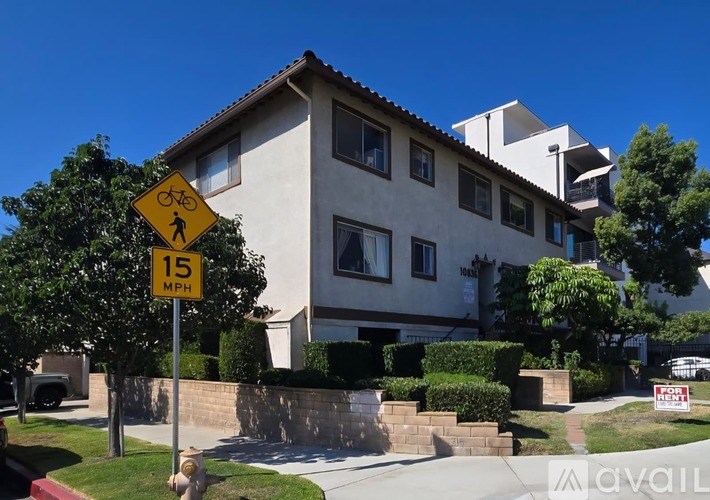 A house with a bicycle crossing sign in front of it.