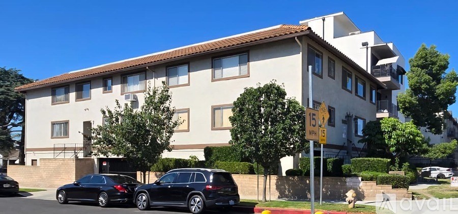 A two-story building with a beige exterior and a red tile roof.