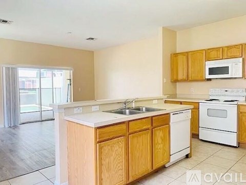 A kitchen with wooden cabinets and white appliances.