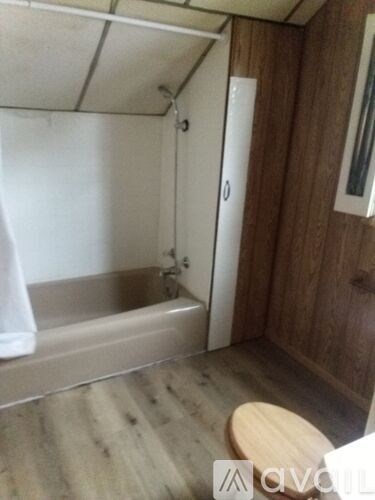 A small bathroom with a toilet and a shower.