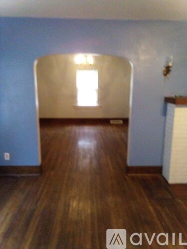 A room with wooden floors and a window.