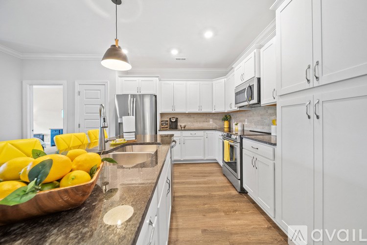 A kitchen with a bowl of lemons on the counter.
