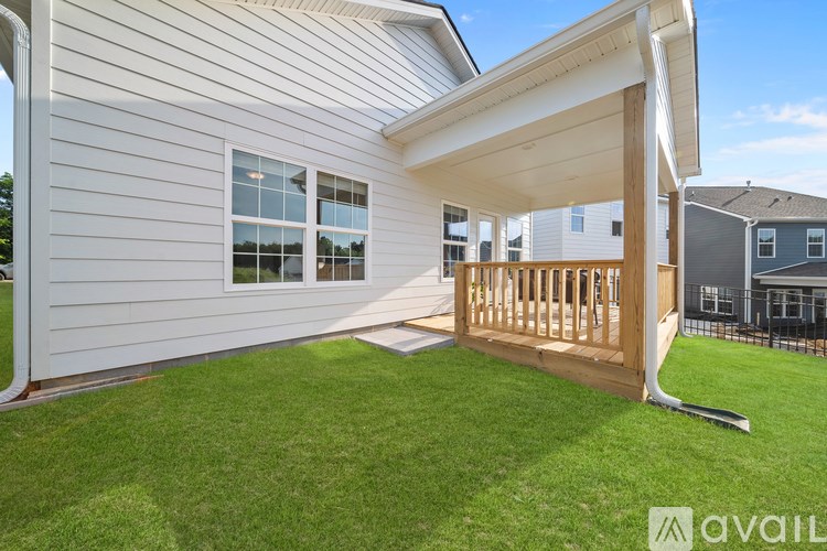 A house with a white exterior and a wooden deck.