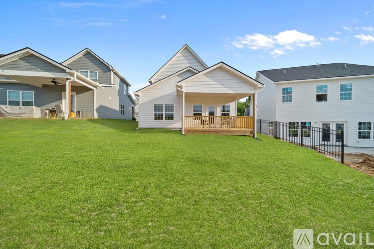 A row of houses with a grassy yard in the foreground.