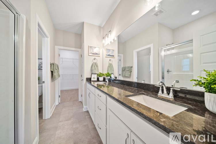 A bathroom with two sinks and a large mirror.
