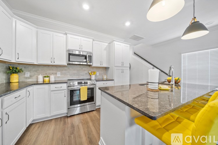 A modern kitchen with white cabinets and a yellow bench.