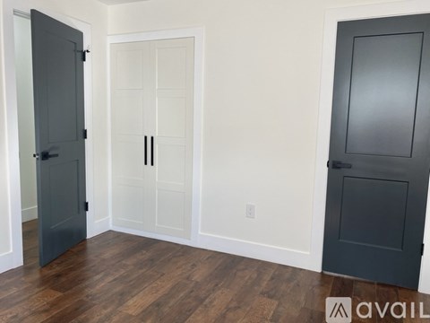 A room with a white door and a black door.