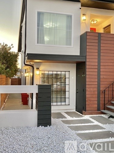 A modern house with a black door and a glass window.
