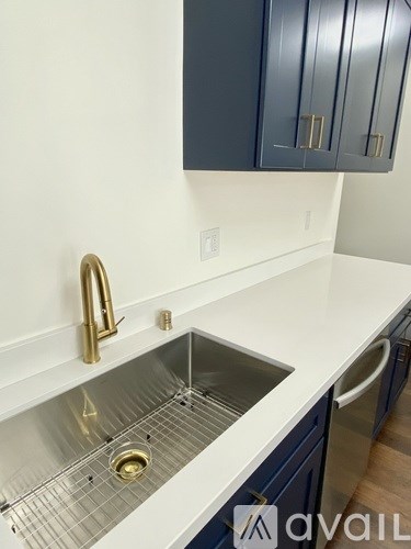 A kitchen with a sink and a cabinet above it.