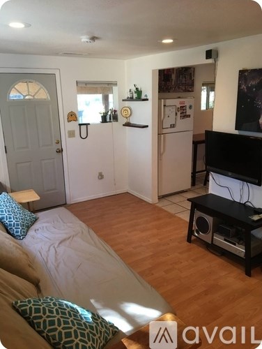 A living room with a couch and a television.