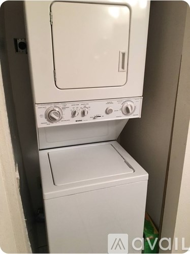 A white washing machine and dryer in a small room.