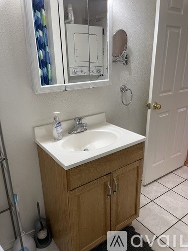 A bathroom with a sink and a mirror above it.