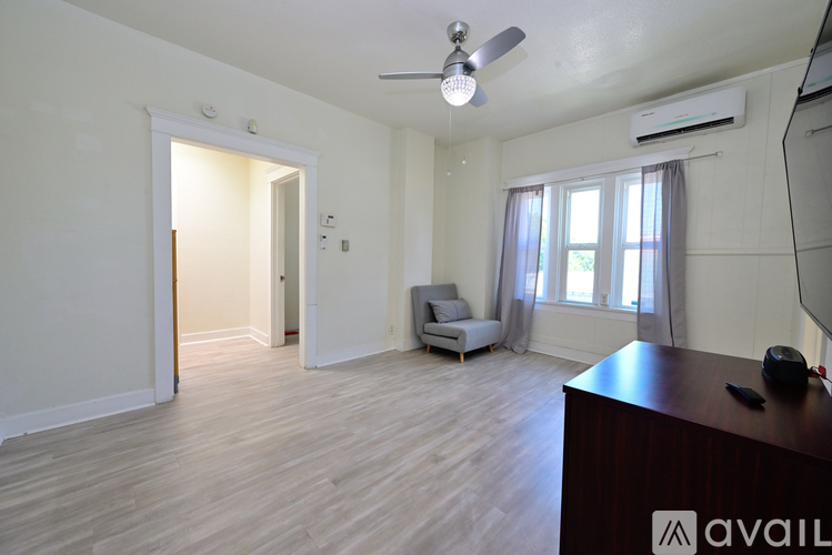 A spacious room with a ceiling fan and a couch.