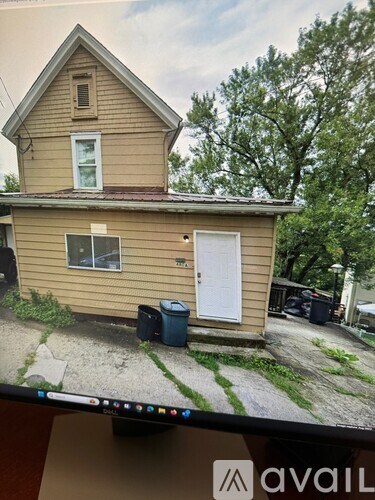 A house with a brown siding and a white door is shown.