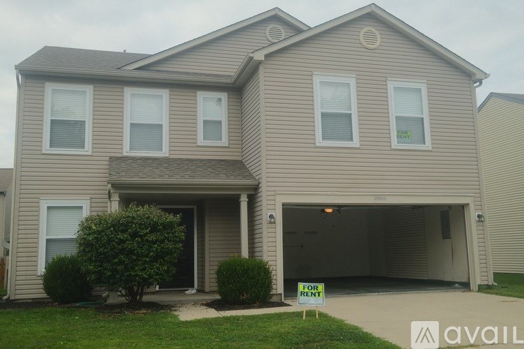 A house with a for sale sign in front of it.