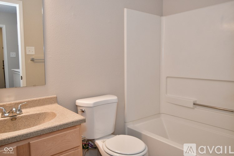 A bathroom with a sink, toilet and bathtub.