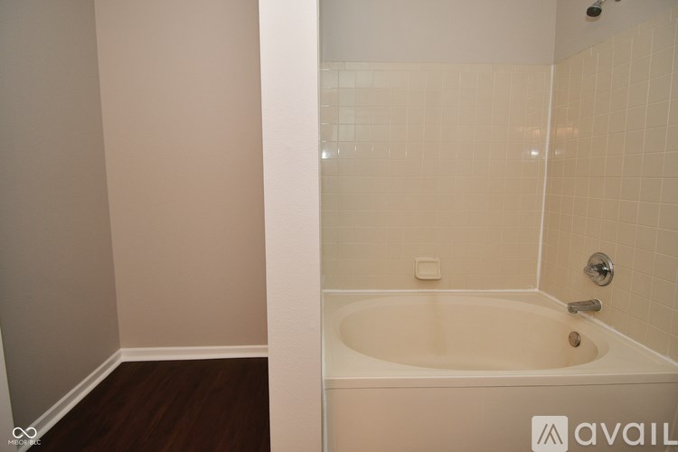 A bathroom with a tub and a shower.