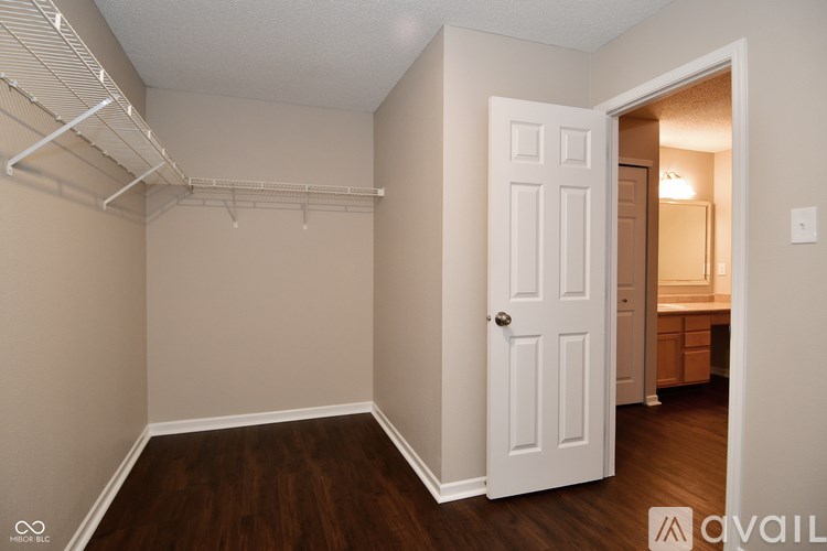 A room with a white door and a white shelf above it.