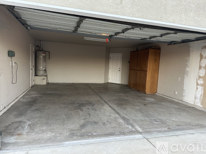 A spacious garage with a concrete floor and a white ceiling.