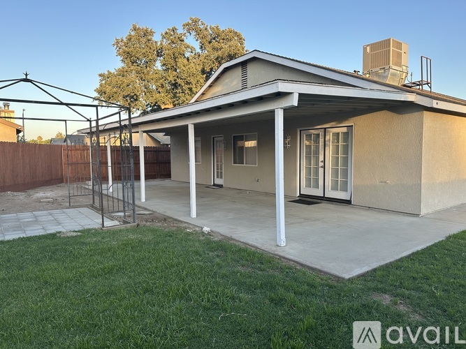 A house with a covered patio and a fence.