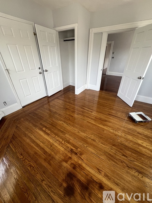 A room with wooden floors and white doors.
