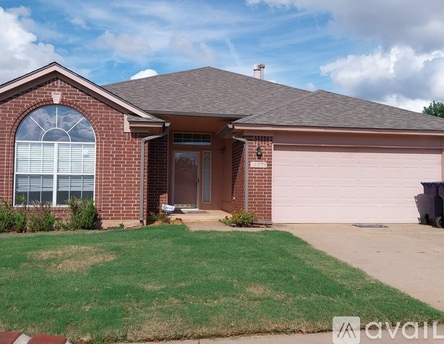A house with a brown brick exterior and a grey roof.