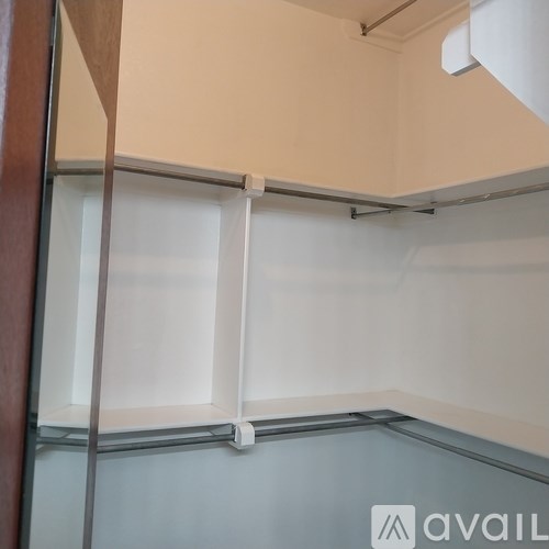 A white shelf with a white roller blind on it.