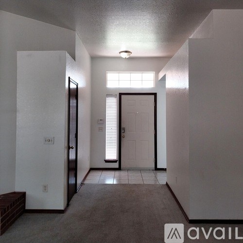 A hallway with a door on the right and a door on the left.