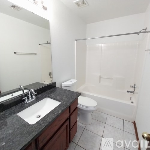 A bathroom with a sink, toilet, and bathtub.