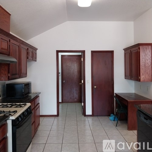 A kitchen with a stove top oven and a microwave.