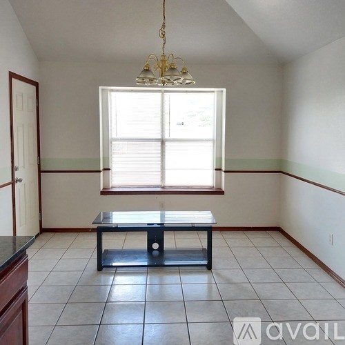 A room with a table and a window.