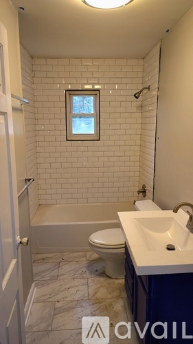 A bathroom with a toilet, sink, and bathtub.