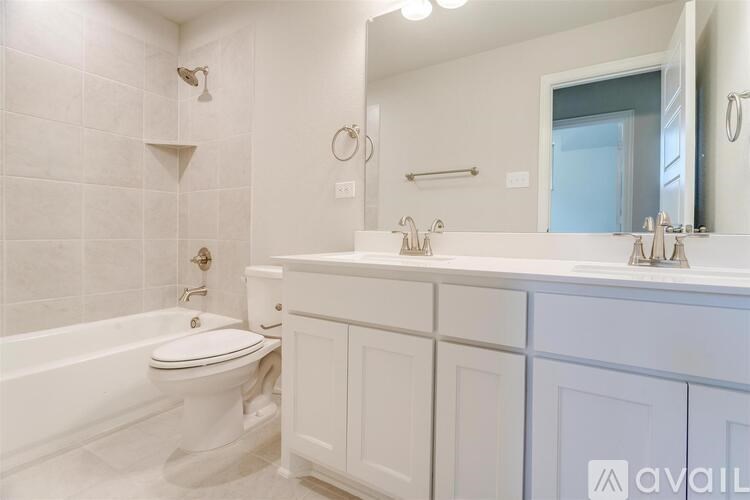 A white bathroom with a toilet, sink, and tub.